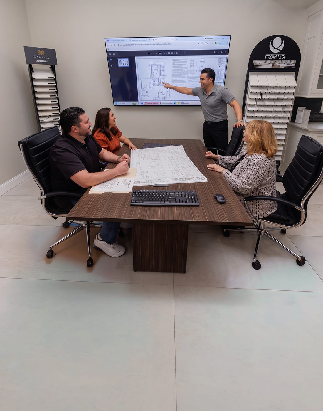 Kitchen designer reviewing kitchen remodeling plans with homeowner in New Jersey showroom